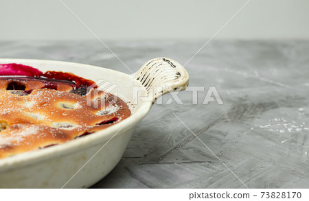 Clafoutis cherry pie - traditional french dessert in a white baking dish 73828170