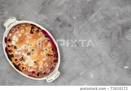 Clafoutis cherry pie - traditional french dessert in a white baking dish 73828172