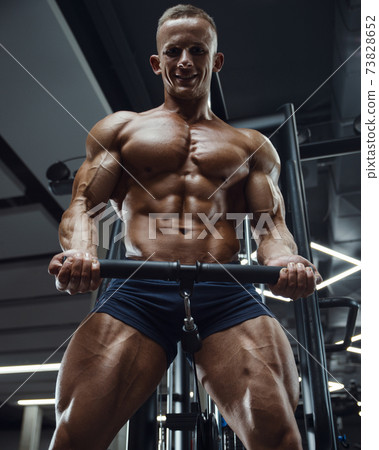 Caucasian man pumping up muscles. fitness training 73828652