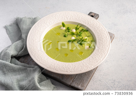 Homemade soup puree of green peas, coconut milk with mini mozzarella cheese 73830936