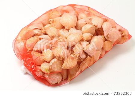Lots of six pieces of garlic in a net that has been loosened apart 73832303