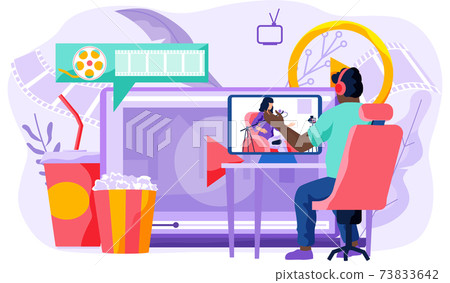 The guy in the headphones looks at the singing girl on the monitor. Online cinema concept The guy in the headphones looks at the singing girl on the monitor. Online cinema concept 73833642