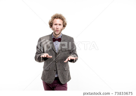 A young successful businessman with curly hair wearing formal suit, isolated on white A young successful businessman with curly hair wearing formal suit, isolated on white 73833675