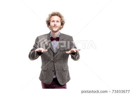 A young successful businessman with curly hair wearing formal suit, isolated on white 73833677