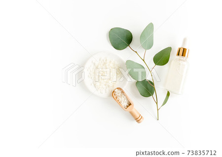 Eucalyptus essential oil, eucalyptus leaves on white background. Natural, Organic cosmetics products. Medicinal, Natural Serums. Flat lay, top view. Eucalyptus essential oil, eucalyptus leaves on white background. Natural, Organic cosmetics products. Medicinal, Natural Serums. Flat lay, top view. 73835712