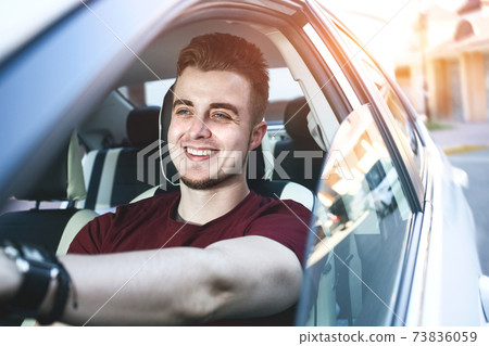 Close up side portrait of happy caucasian man driving car. Close up side portrait of happy caucasian man driving car. 73836059