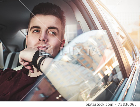 Close up side portrait of happy caucasian man driving car. Close up side portrait of happy caucasian man driving car. 73836063