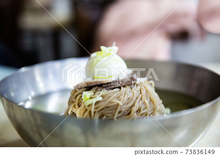 Pyongyang cold noodles with beef, boiled egg, and broth in a soba sari, traditional Korean food 73836149
