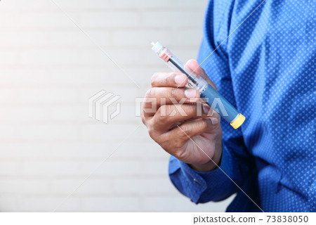 hand holding Insulin pens with copy space, Top down hand holding Insulin pens with copy space, Top down 73838050