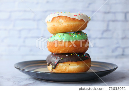 close up of colorful homemade donuts on plate  73838051