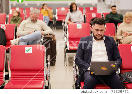 People sitting in terminal airport People sitting in terminal airport 73839771