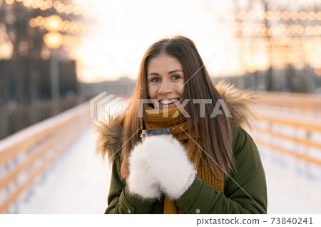 Woman warming up with hot tea Woman warming up with hot tea 73840241