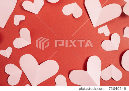 Valentine's day background. Pink hearts laid out in the form of a frame on a pastel red background. Valentine's day concept. Layout for postcards and congratulations. Flat lay, top view, copy space Valentine's day background. Pink hearts laid out in the form of a frame on a pastel red background. Valentine's day concept. Layout for postcards and congratulations. Flat lay, top view, copy space 73840246