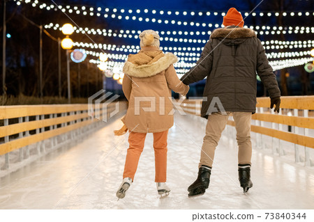 Couple learning to skate Couple learning to skate 73840344