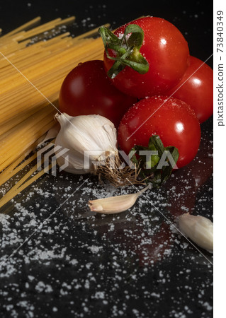 Pasta and ingredients for cooking - tomatoes, garlic, salt. Copy space Pasta and ingredients for cooking - tomatoes, garlic, salt. Copy space 73840349