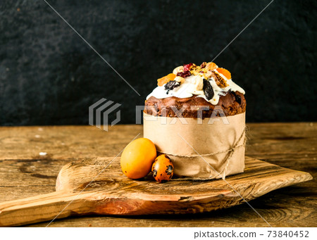 Easter cake and eggs on a wooden board. Still life on a black Easter cake and eggs on a wooden board. Still life on a black 73840452