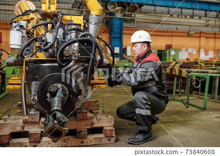 Worker in factory on the machine 73840608