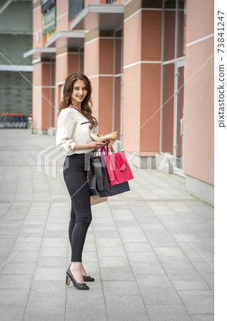 Woman showing modern heeled shoes 73841247
