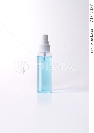 Blue alcohol bottle spray isolated with clipping path. Covid-19 concept. Blue alcohol bottle spray isolated with clipping path. Covid-19 concept. 73842387