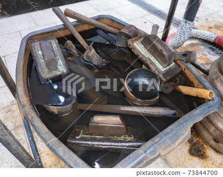 Metal table with water pool, wet wooden forms and glass scissors Metal table with water pool, wet wooden forms and glass scissors 73844700