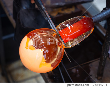 Glassworks glass manufacturing. Manual process of forming a decorative vase Glassworks glass manufacturing. Manual process of forming a decorative vase 73844701
