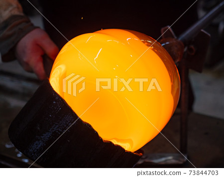 Glassworks glass manufacturing. Manual process of forming a decorative vase Glassworks glass manufacturing. Manual process of forming a decorative vase 73844703