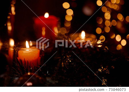 New Year's candles in Christmas trees with beautiful sides in the background in the New Year and Christmas 73846073