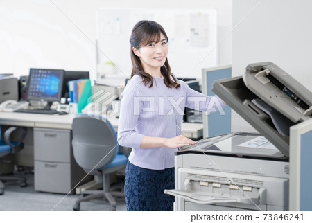 Female employee making a copy in the office 73846241