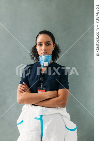 Confident nurse with medical respirator under her chin Confident nurse with medical respirator under her chin 73846851