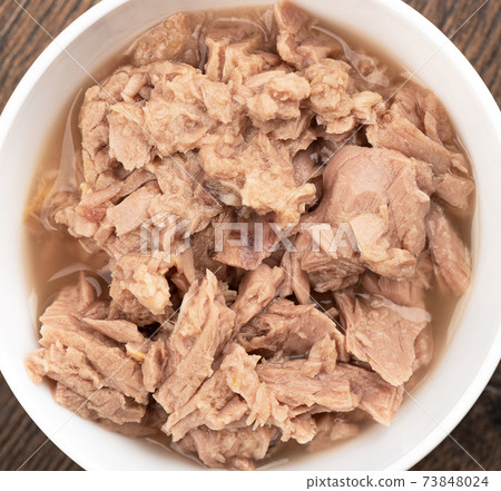 Close-up of a white bowl filled with canned tuna. Close-up of a white bowl filled with canned tuna. 73848024