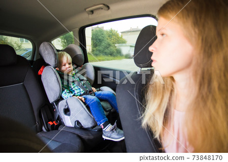 Mom need to drive a car and looks back at her son Mom need to drive a car and looks back at her son 73848170