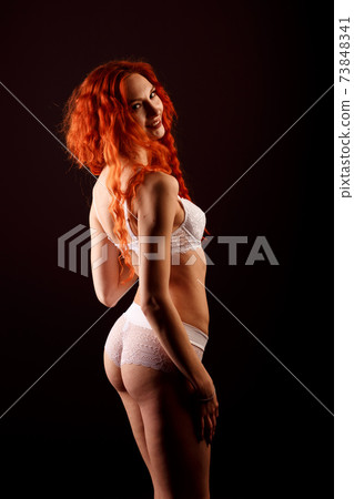 Sexy woman in lingerie in black background, red hair Sexy woman in lingerie in black background, red hair 73848341