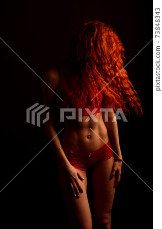 Sexy woman in lingerie in black background, red hair Sexy woman in lingerie in black background, red hair 73848343