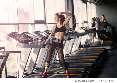 Young woman exercise fitness and workout while run on track in sport club Young woman exercise fitness and workout while run on track in sport club 73848379