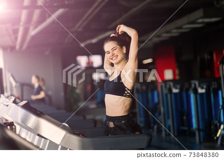 Young woman exercise fitness and workout while run on track in sport club 73848380