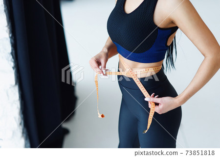 Woman with beautiful waist using measure tape, healthy lifestyles concept. 73851818