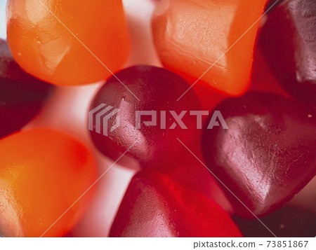 Close-up texture of red, orange and purple multivitamin gummies. Healthy lifestyle concept. Close-up texture of red, orange and purple multivitamin gummies. Healthy lifestyle concept. 73851867