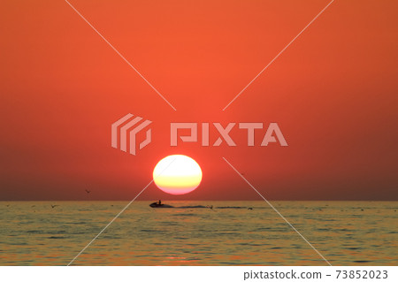 man enjoys life while riding a water bike on the background of a sunset in the sea man enjoys life while riding a water bike on the background of a sunset in the sea 73852023