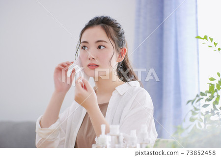 A young woman who cares about rough skin caused by a mask 73852458