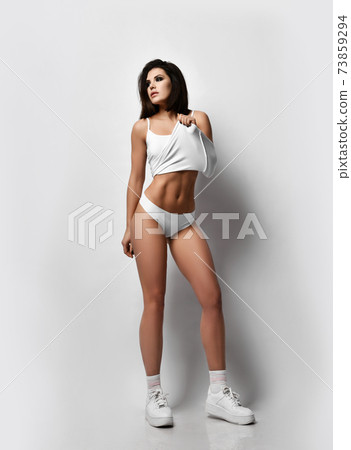 Young sexy fitness brunette woman in white Young sexy fitness brunette woman in white 73859294