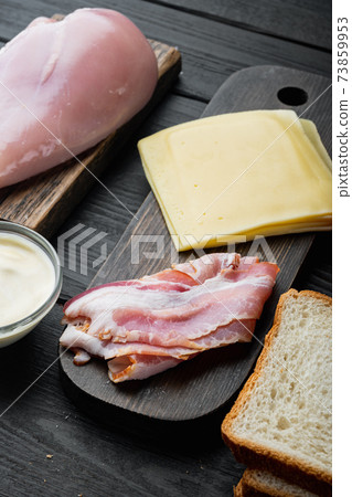 Club sandwich with fresh ingredients, on black wooden background 73859953