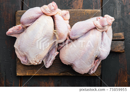 Fresh whole poult, on old wooden table, top view 73859955