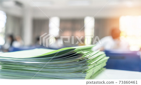Exam answer sheet pile, blurry application document paperwork stack on office work table in examination room or classroom with blur education background school class university students taking test Exam answer sheet pile, blurry application document paperwork stack on office work table in examination room or classroom with blur education background school class university students taking test 73860461
