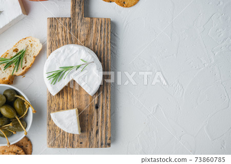 French soft camembert of normandy cheese, on white background, flat lay with copy space for text French soft camembert of normandy cheese, on white background, flat lay with copy space for text 73860785
