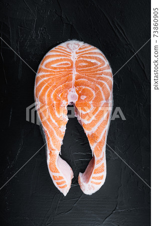 Salmon steak raw fish, over black background, top view Salmon steak raw fish, over black background, top view 73860905