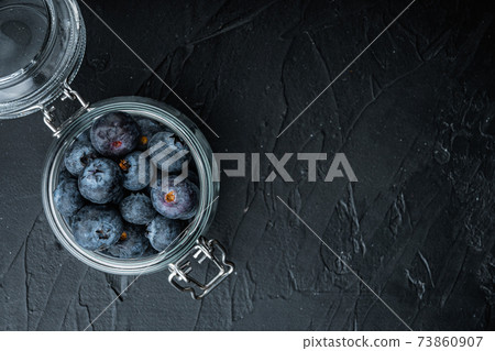 Blueberry in glass jar, flat lay with space for text, on black background Blueberry in glass jar, flat lay with space for text, on black background 73860907