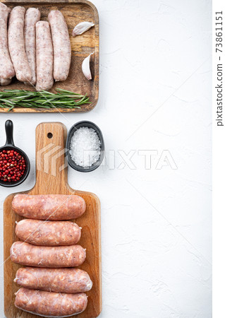 Assorted raw homemade sausages, flat lay with space for text, on white background Assorted raw homemade sausages, flat lay with space for text, on white background 73861151