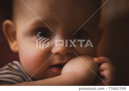 Teething in babies. Caucasian baby. Selective focus. 73862599