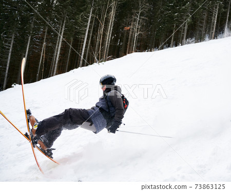 Winter kinds of sport. Skier doing tricks in the mountains in winter season Winter kinds of sport. Skier doing tricks in the mountains in winter season 73863125