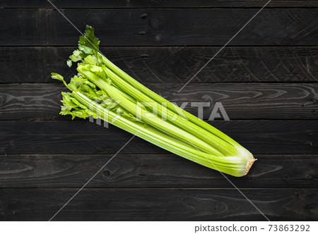 Celery branch bunch on concrete background 73863292